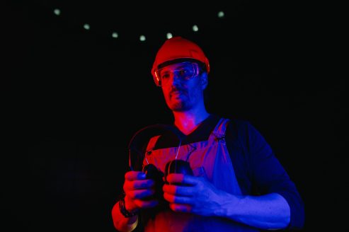 Worker at construction site in neon light